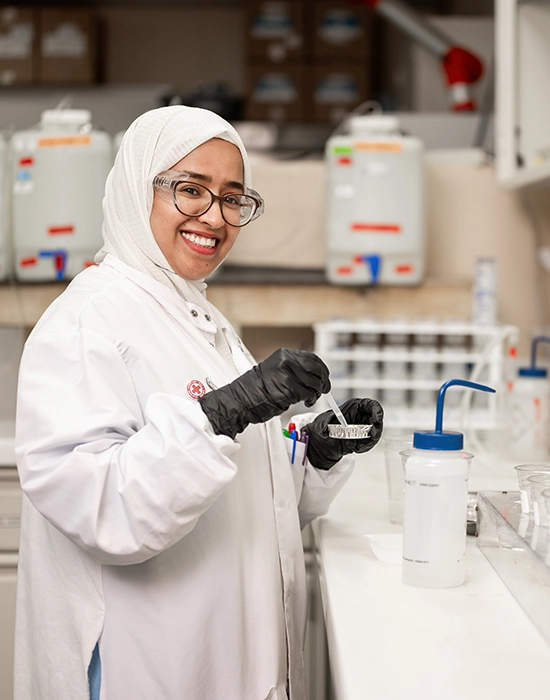 Pace scientist working in lab smiling at camera